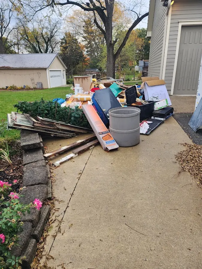 Dumpster being loaded with debris for Roofing Dumpster Rental in Temescal Valley
